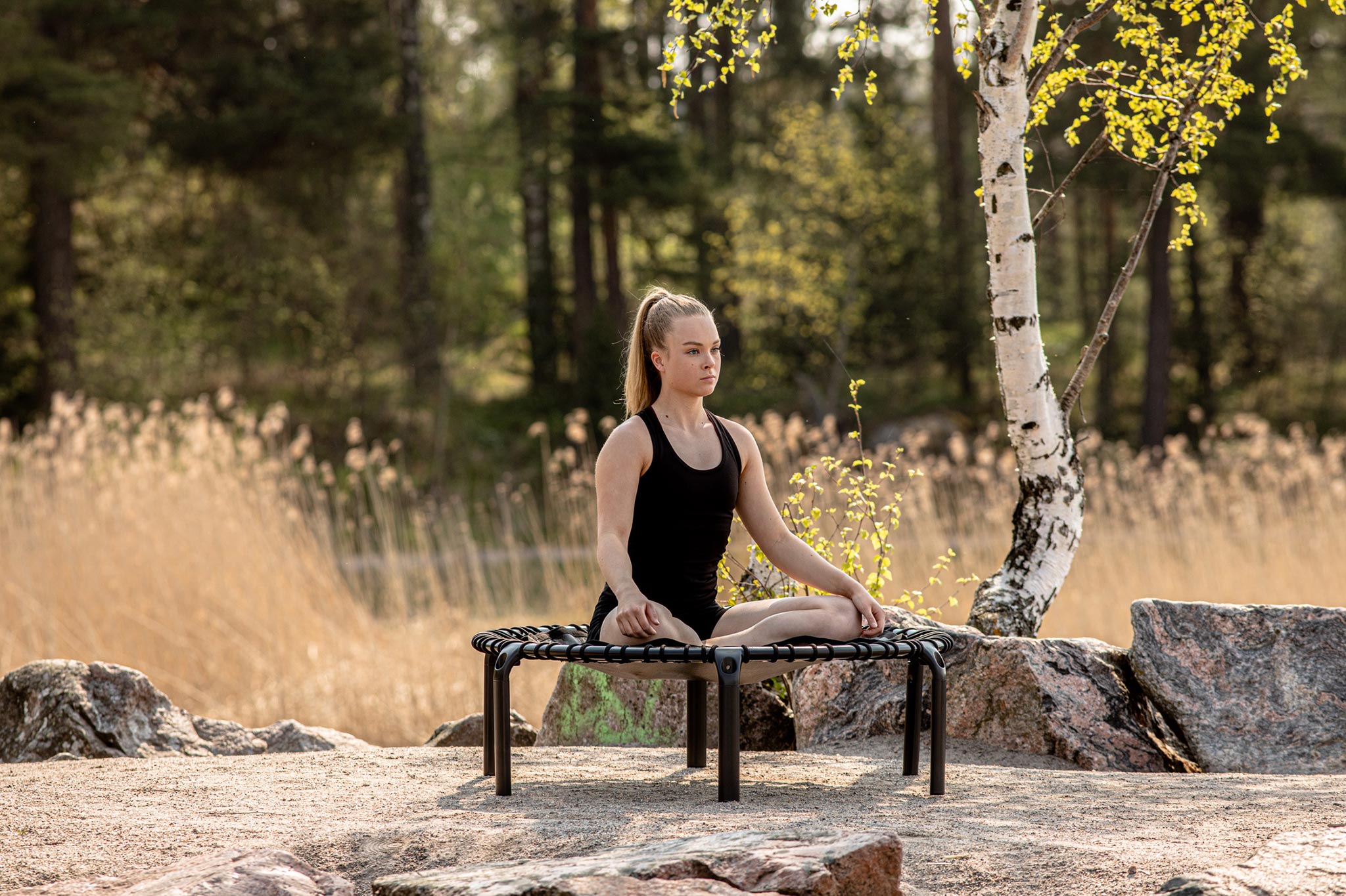 Outdoor yoga moment on a fitness trampoline