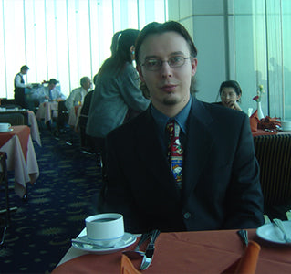 Acon story - a business person sitting with a cup of coffee next to them