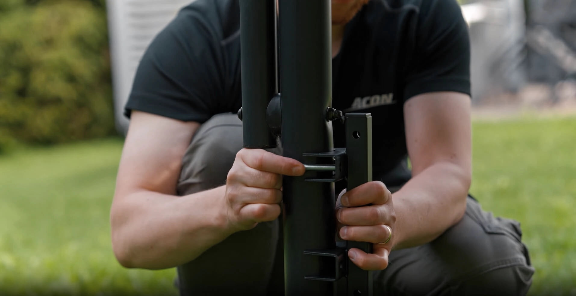 Man assembling an Acon Trampoline, close-up of hands.