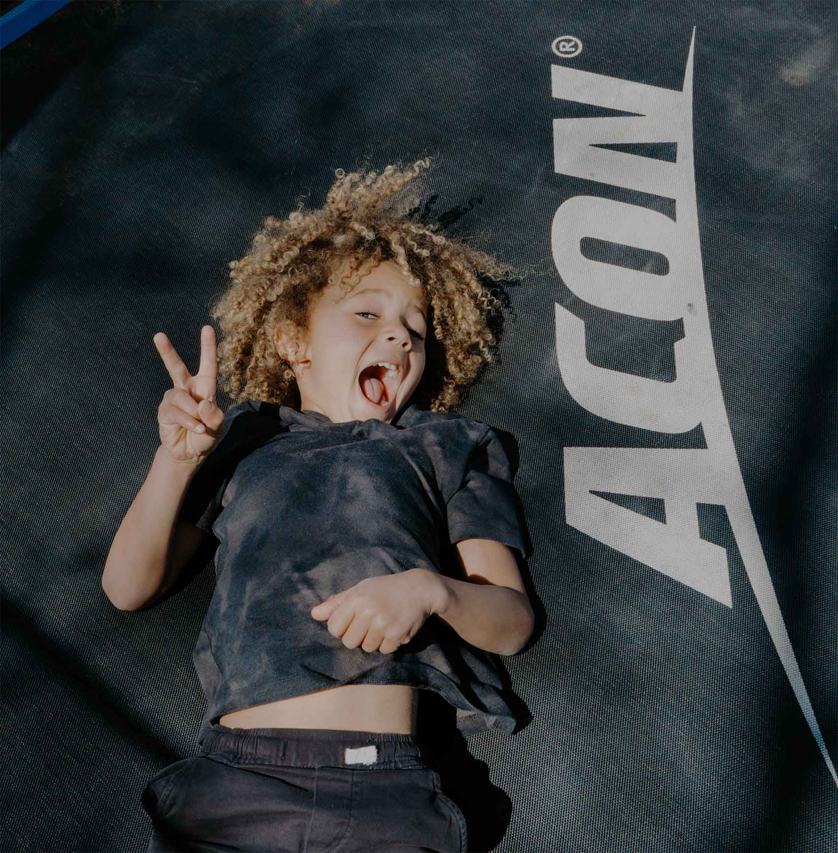 A happy kid on the Acon HD Trampoline.