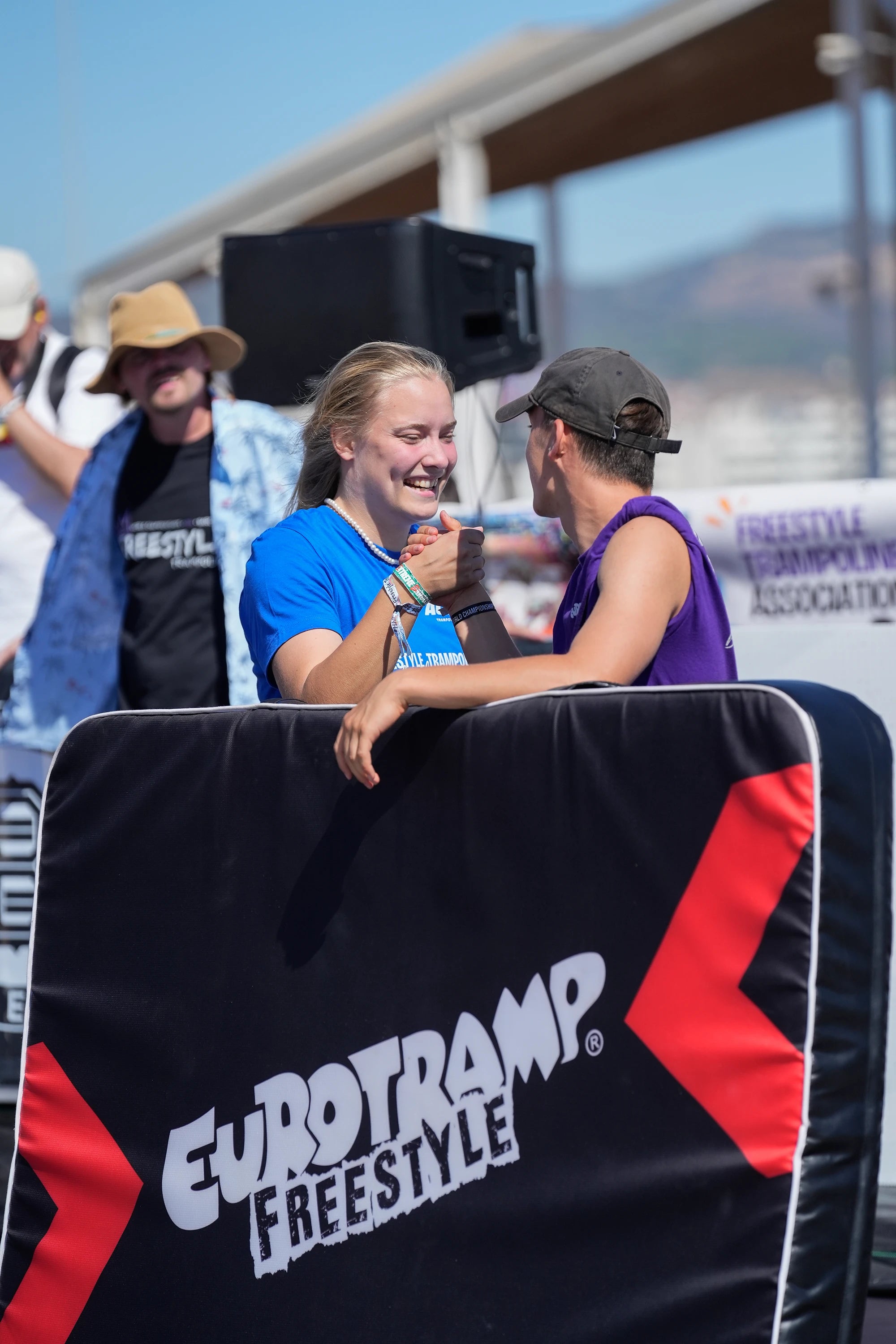 Trampoline contest competitors shaking their hands.