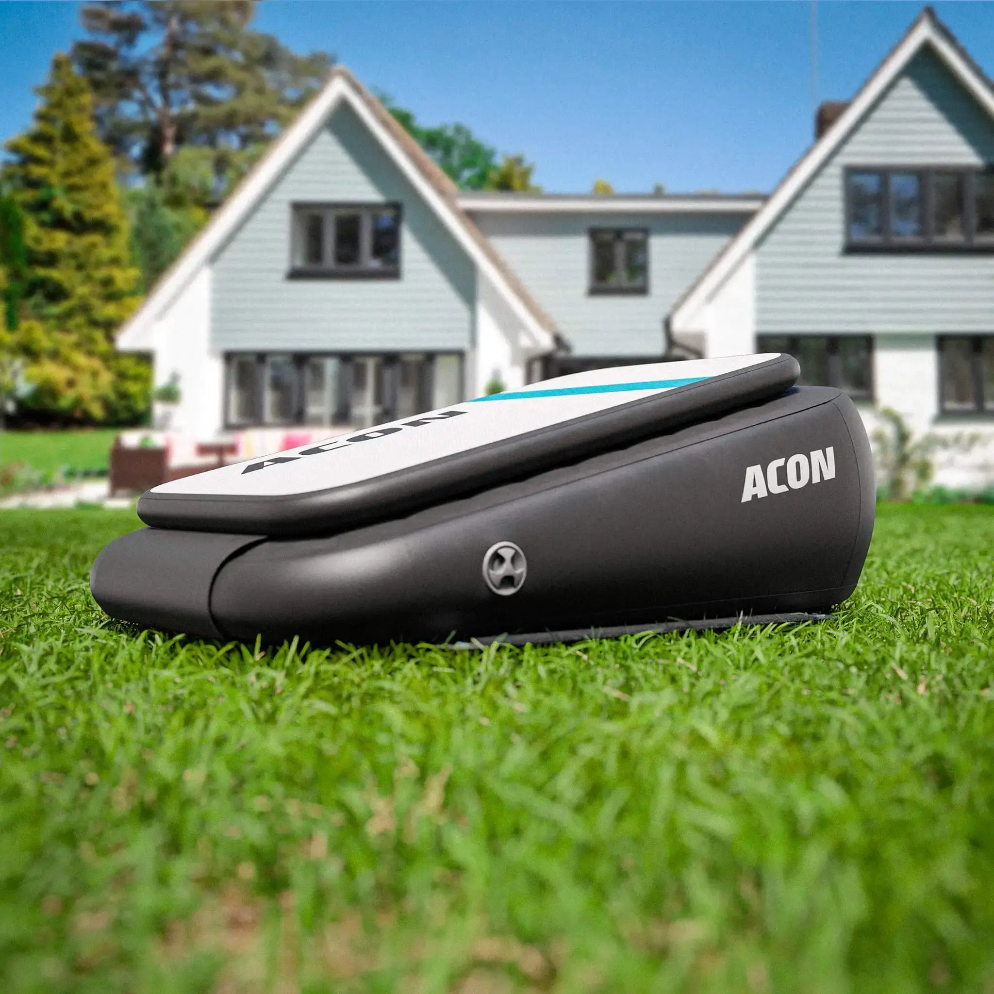 ACON inflatable airboard with adjustable bounce, on grassy front yard.