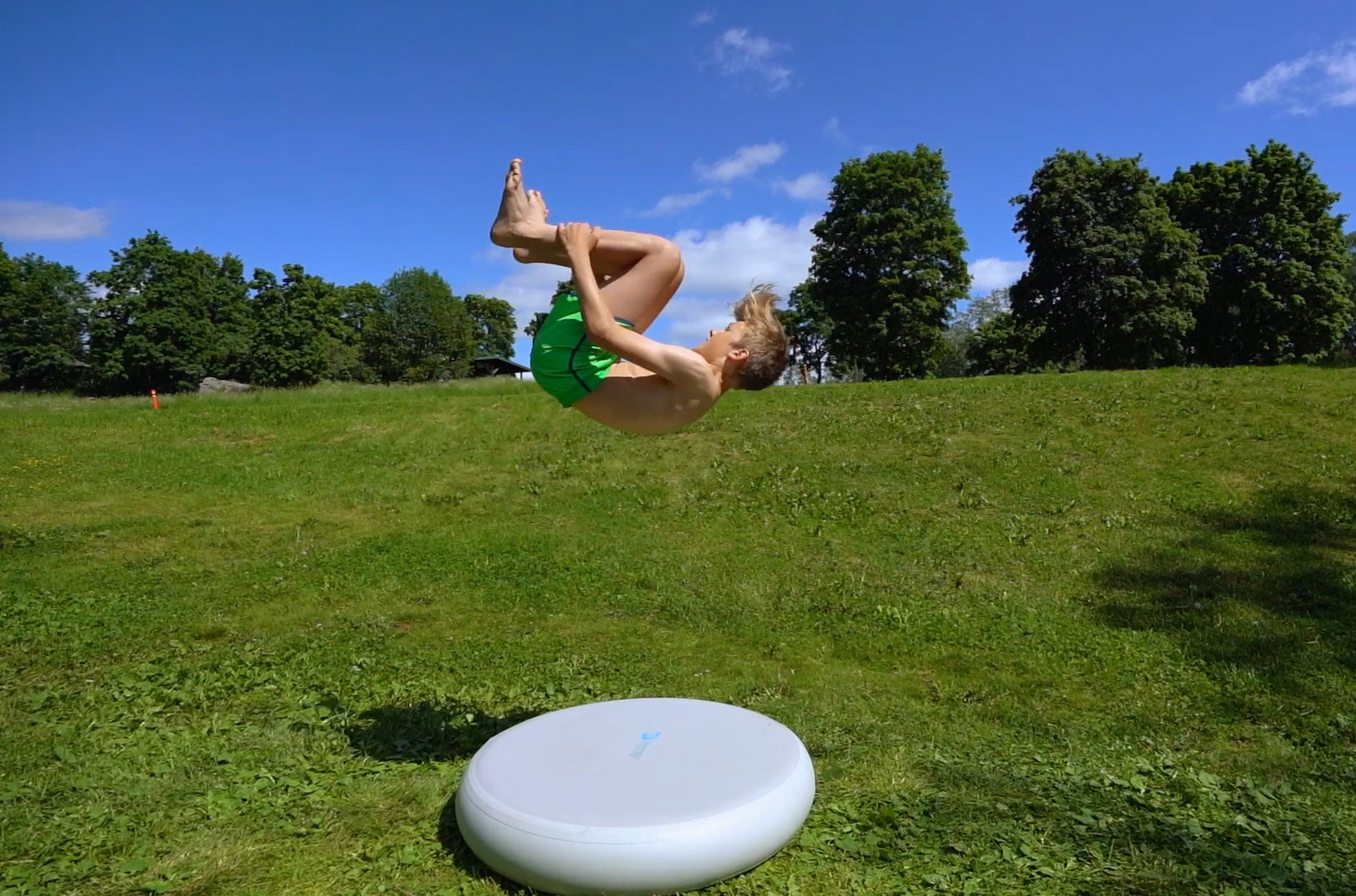 A kid volting on Acon airspot, summer park view