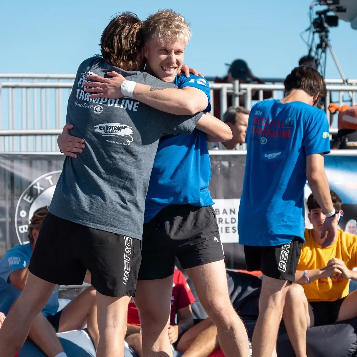 Two freestyle trampoline athletes hugging each other at the 2024 World Championships in Barcelona.