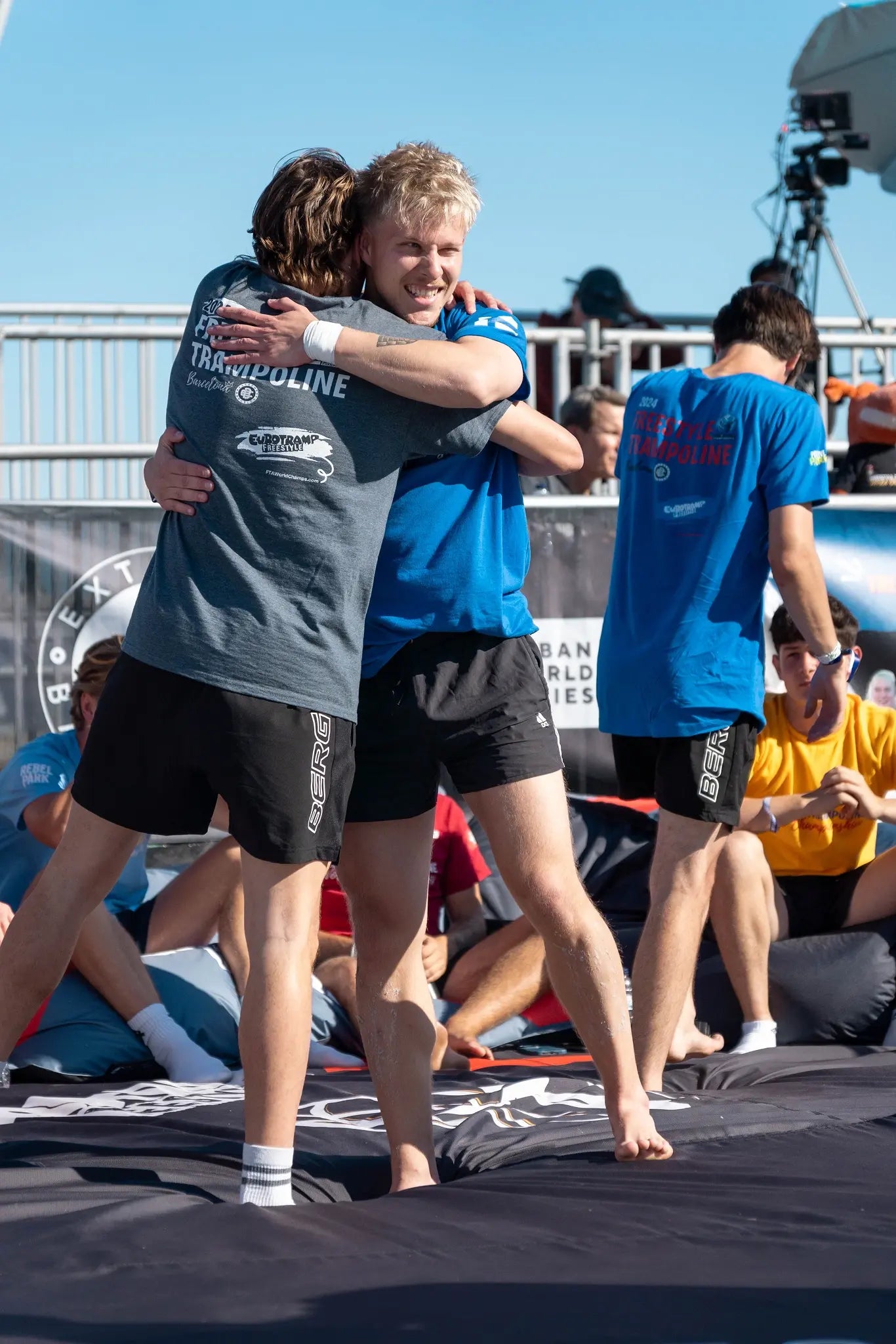 Two freestyle trampoline athletes hugging each other at the 2024 World Championships in Barcelona.