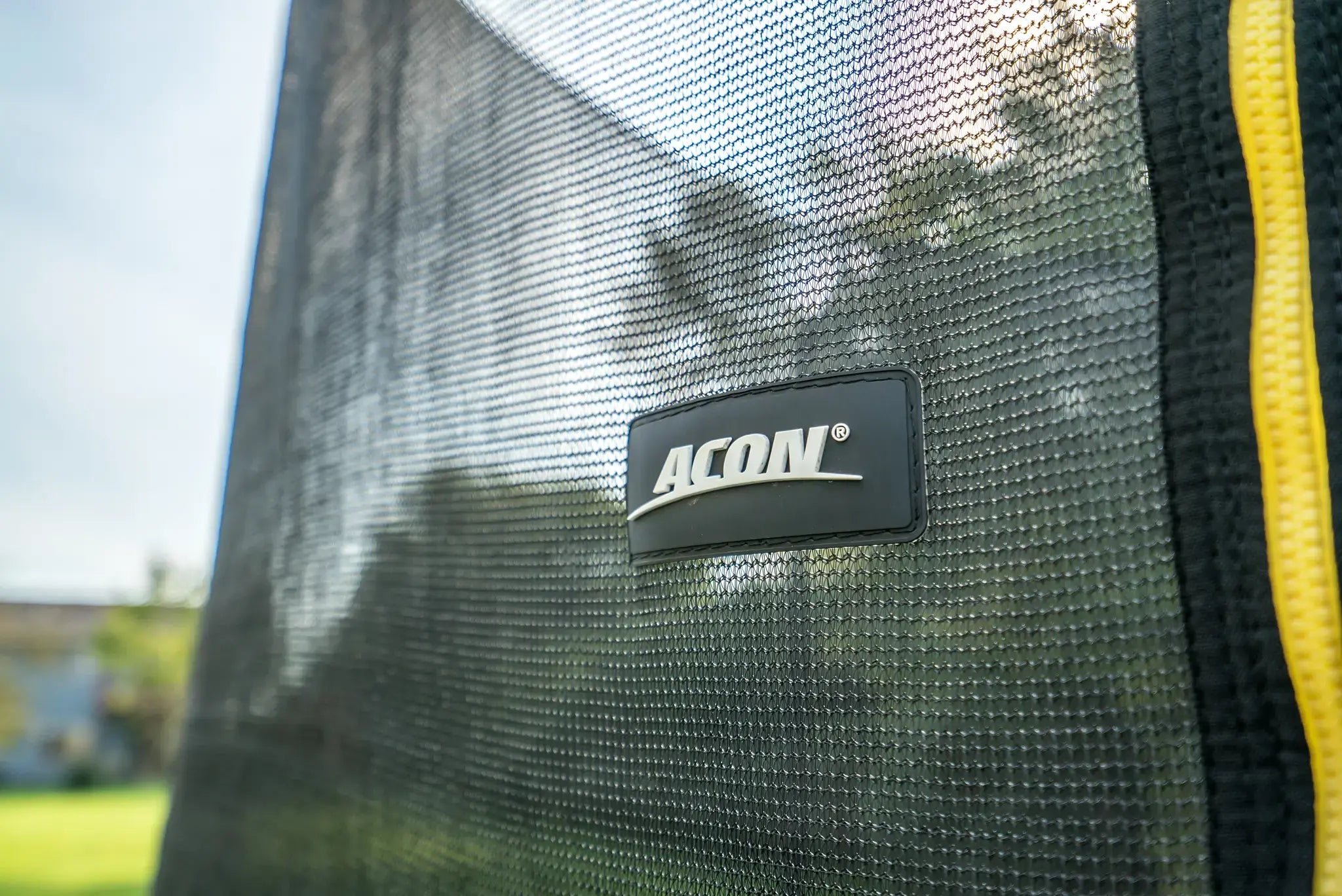 Close up picture of Acon trampoline's safety net with Acon logo. 