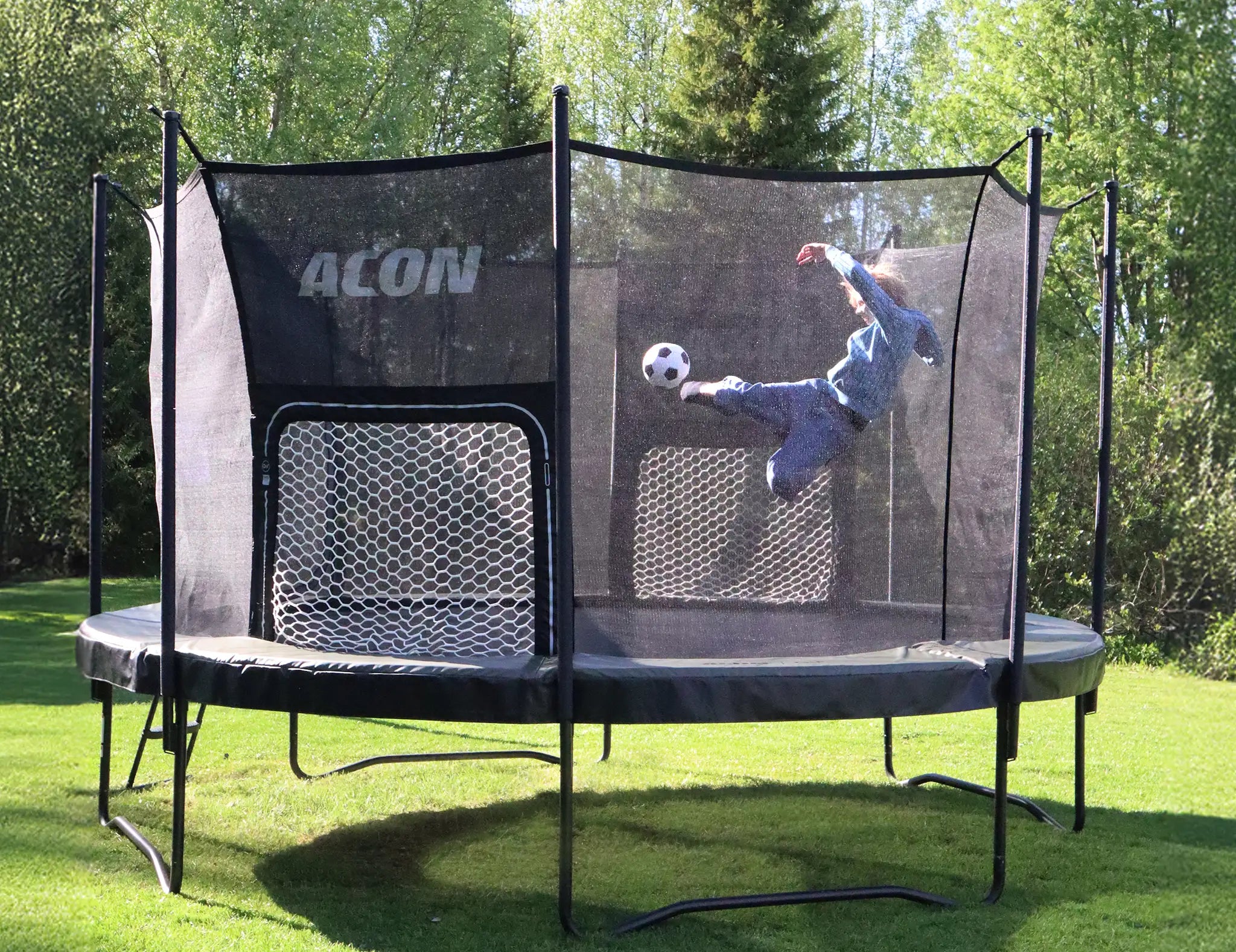 Person performing soccer kick on Acon trampoline with goal net for backyard sports play.