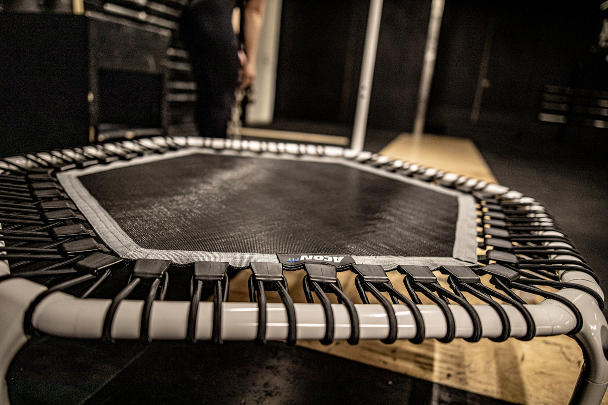 A closeup of a white fitness trampoline at a gym 