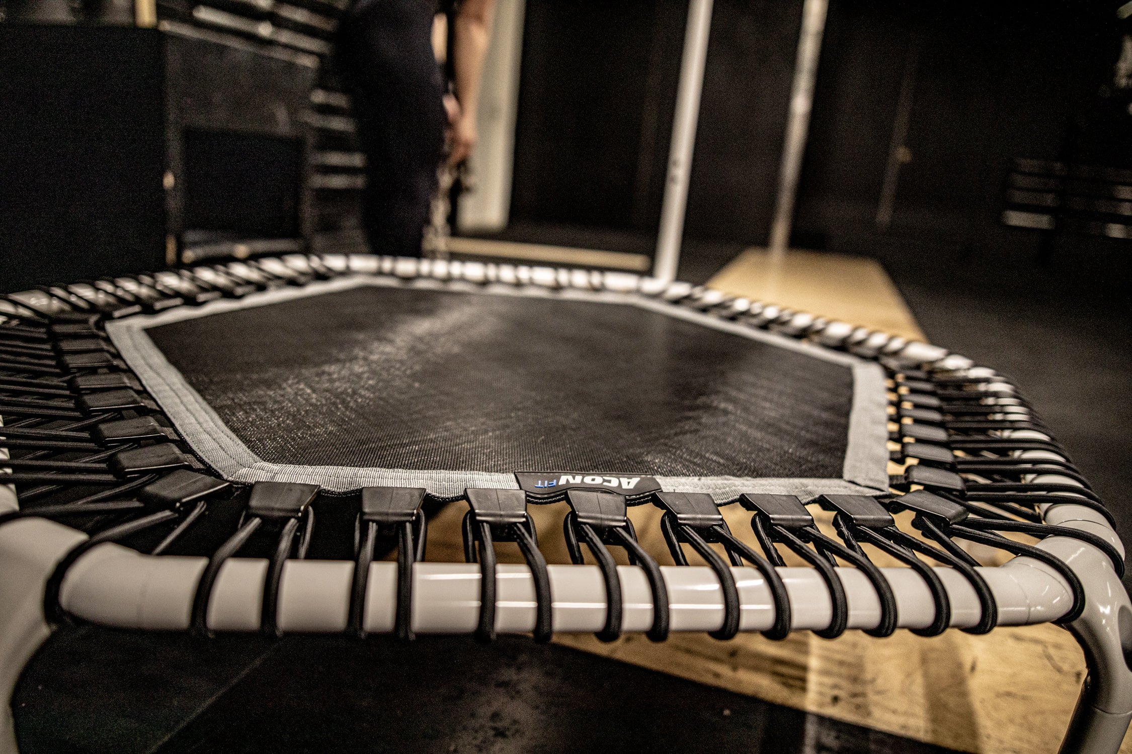 A closeup of a white fitness trampoline at a gym 