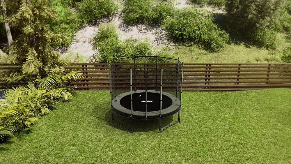 Small Acon Air round trampoline on backyard surrounded by green grass. 