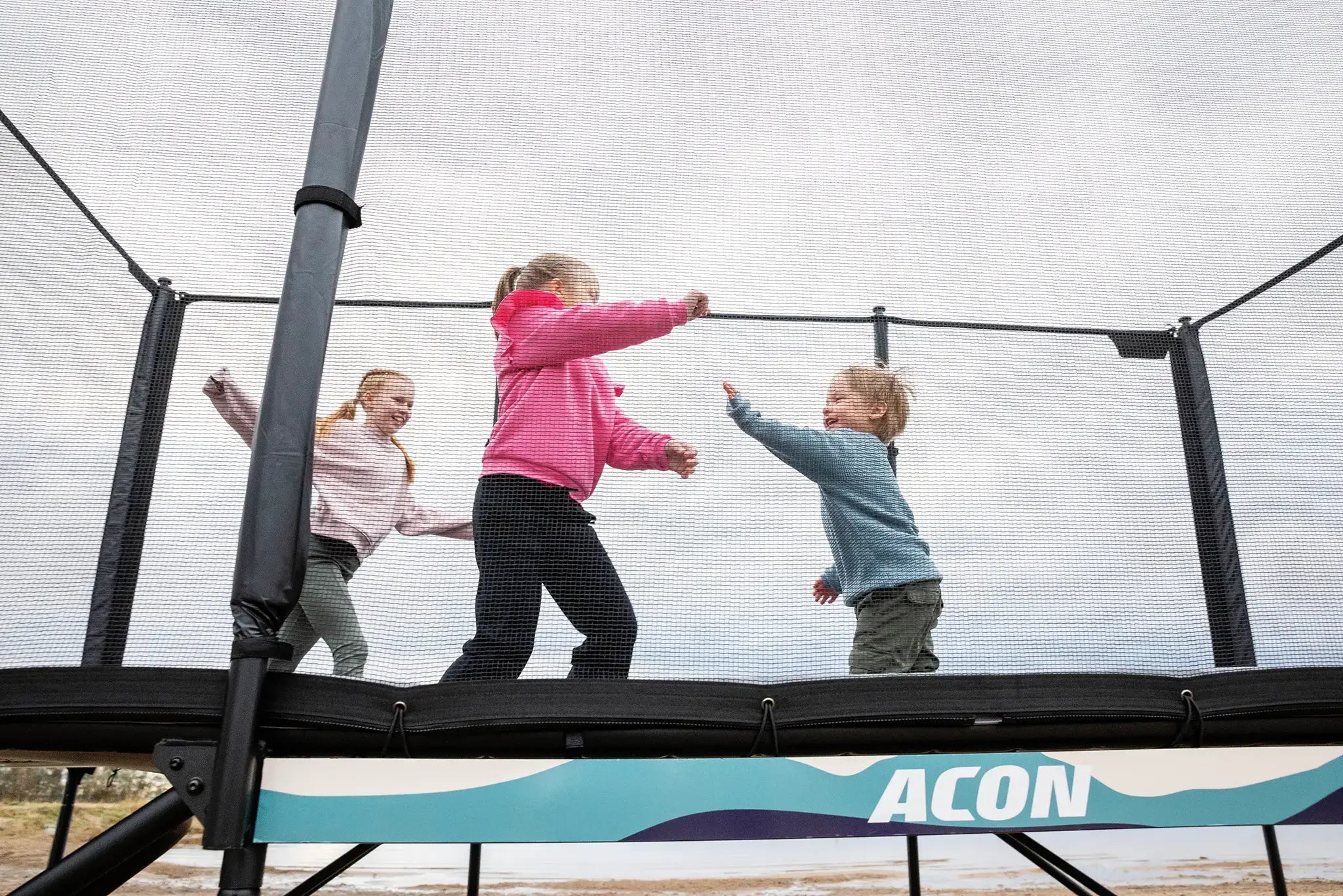 Children playing on a Acon X trampoline. 