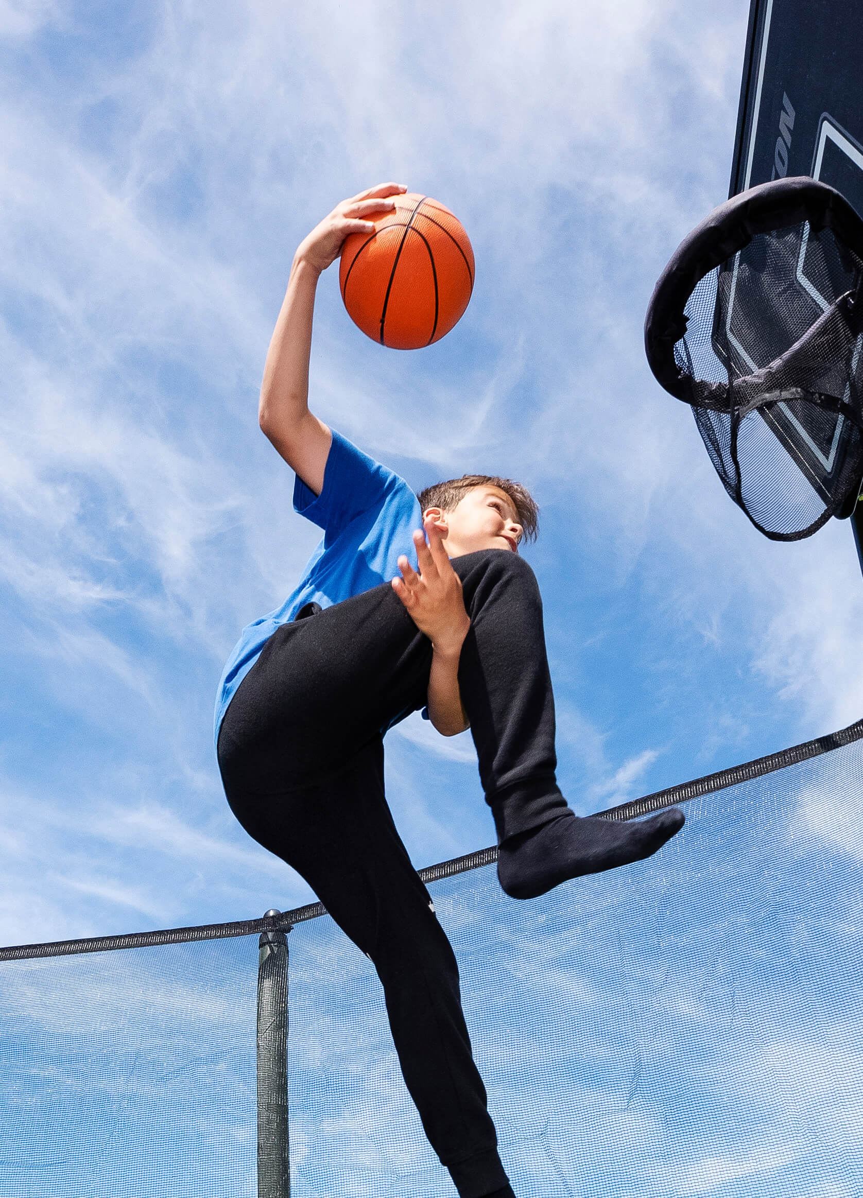 Kid playing Acon Trampoline Basketball.