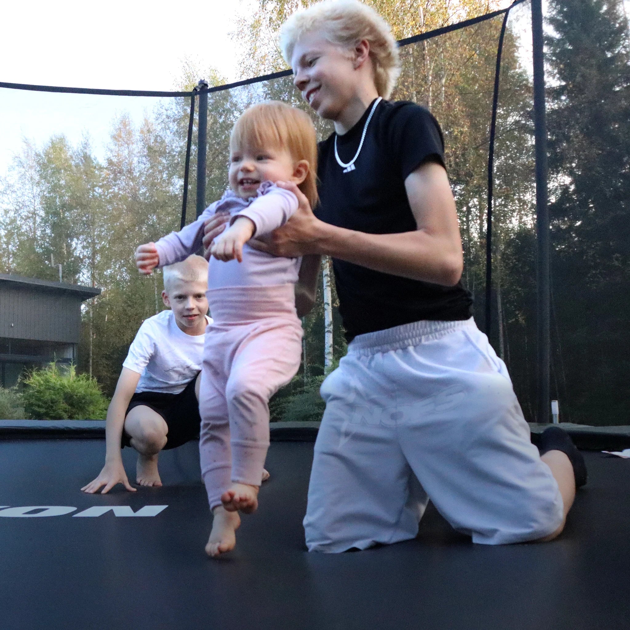 Two boys and a toddler on an Acon Air trampoline.