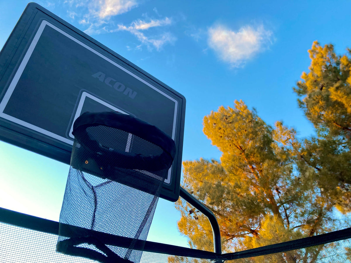 Trampoline basketball hoop and sky.