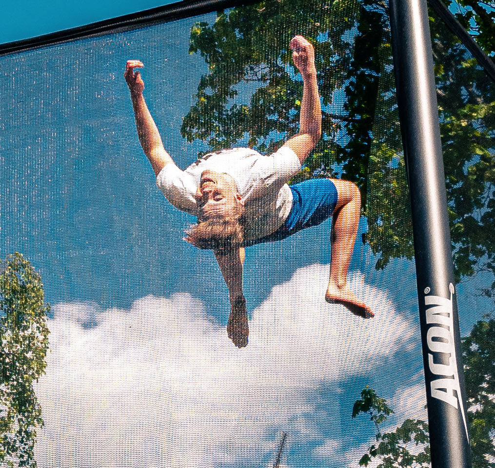 A trampoline jump within a safety net