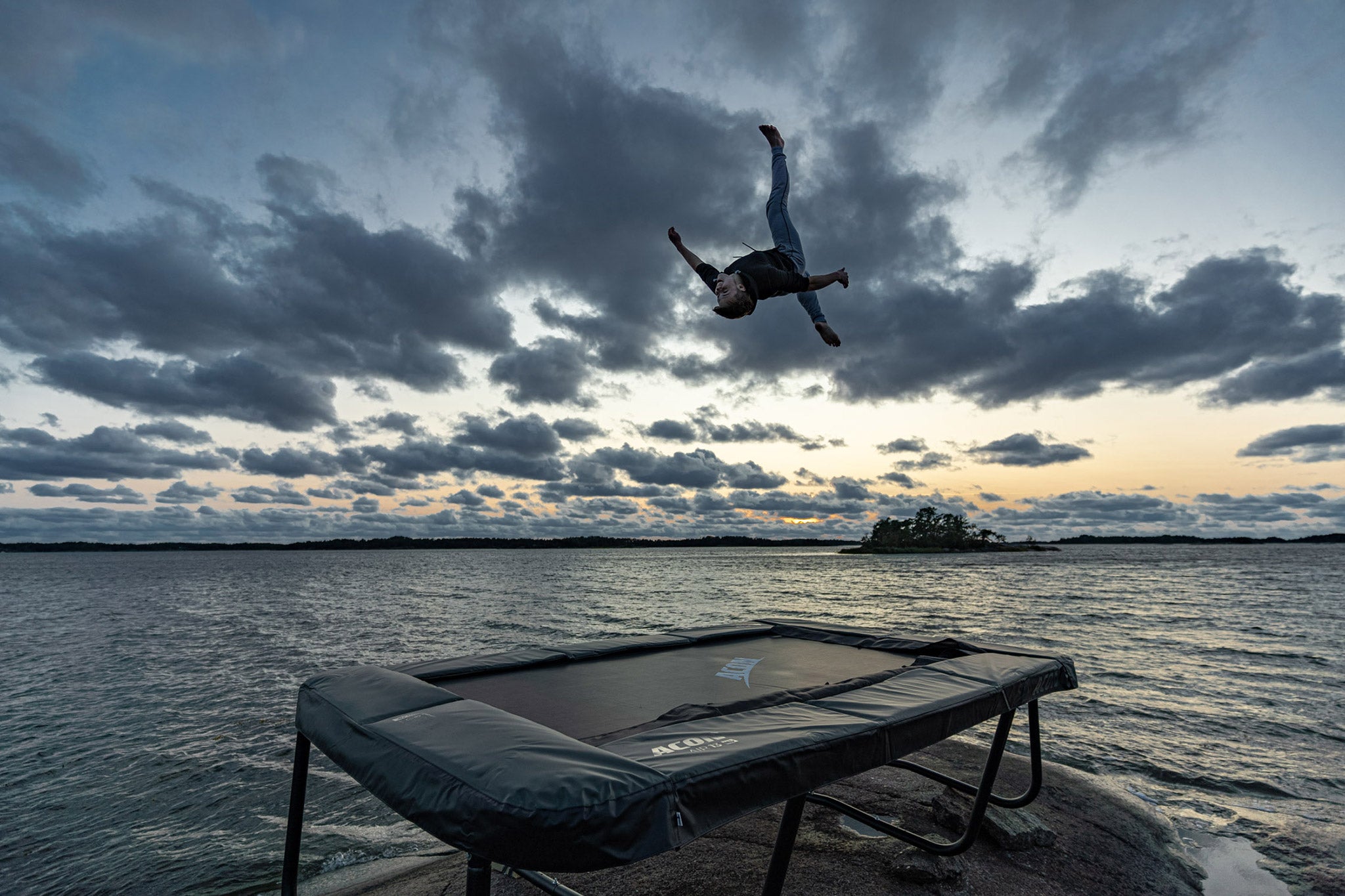 Bouncer on a rectangle 13HD trampoline in Nordic landscape