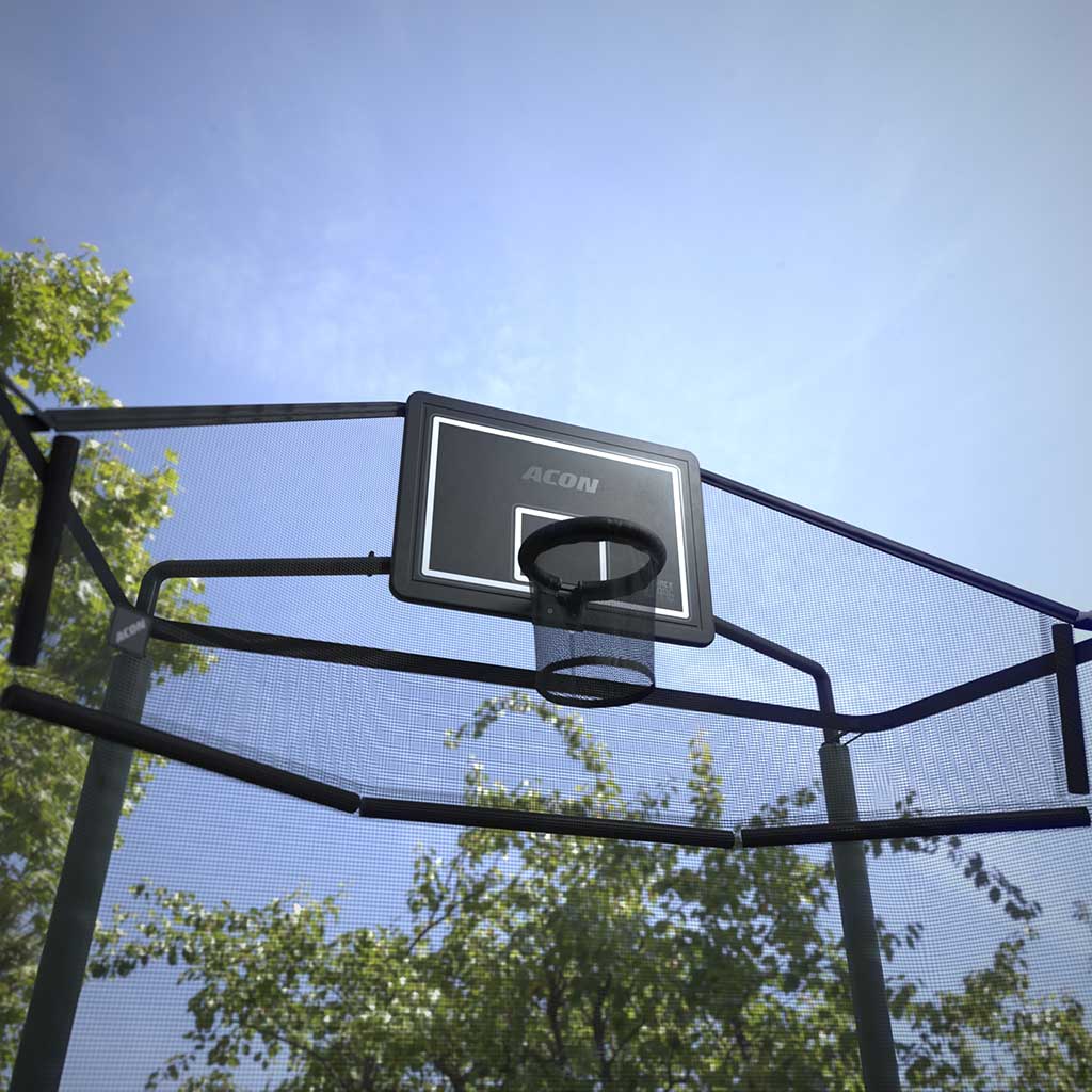 Outdoors image of an Acon Basketball Hoop Back Net mounted on a rectangular trampoline