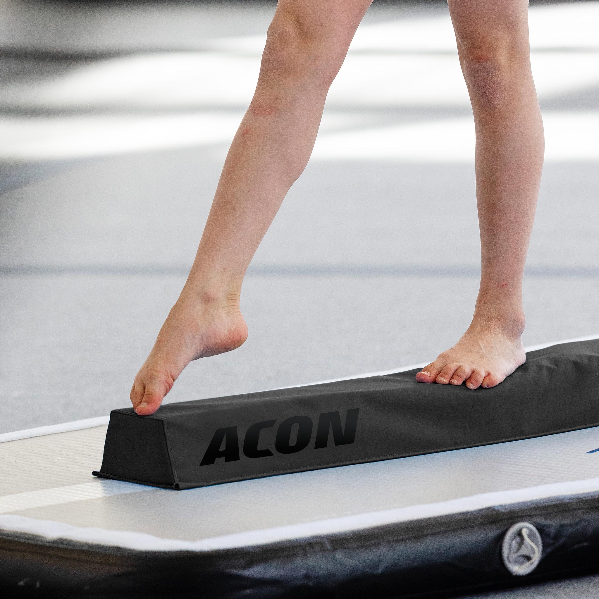 Detail of gymnast's legs with Acon Gym Beam for Gymnastics.